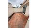 Private outdoor patio with tiled floor and block wall, providing a relaxing retreat at 7969 Cina Ave, Las Vegas, NV 89147