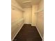 Spacious walk-in closet featuring custom shelving and dark wood-look flooring, perfect for organized storage solutions at 7969 Cina Ave, Las Vegas, NV 89147