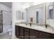 Well-lit bathroom featuring a double sink vanity with granite countertop and a shower-tub combo at 8 Laricola Ct, Henderson, NV 89011