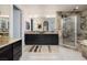 Bathroom featuring a double vanity, stone shower, and tub at 8 Laricola Ct, Henderson, NV 89011