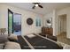 Stylish bedroom featuring a walkout to a patio, shuttered windows, and sleek modern furnishings at 8 Laricola Ct, Henderson, NV 89011