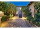 Inviting entrance showcasing a stone walkway leading to an elegant front door flanked by manicured landscaping at 8 Laricola Ct, Henderson, NV 89011