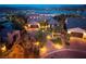 Stunning exterior view of a luxury home with brick driveway, professional landscaping, and lake view at 8 Laricola Ct, Henderson, NV 89011