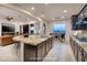Open kitchen area with a large island featuring granite countertops and barstool seating at 8 Laricola Ct, Henderson, NV 89011