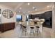 Open kitchen area with a large island featuring granite countertops and black appliances at 8 Laricola Ct, Henderson, NV 89011