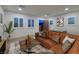 Cozy living area with plush leather seating, plantation shutters, and a fun foosball table at 8 Laricola Ct, Henderson, NV 89011