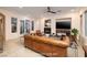 Staged living room featuring brown leather furniture, fireplace, mounted TV, and view of outdoor patio at 8 Laricola Ct, Henderson, NV 89011