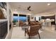 Open living room with fireplace, and large windows for outdoor views that opens to the kitchen at 8 Laricola Ct, Henderson, NV 89011