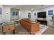 Spacious living room featuring a comfortable leather couch and a foosball table for entertainment at 8 Laricola Ct, Henderson, NV 89011