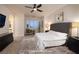 Comfortable main bedroom with a large bed, ceiling fan, plantation shutters, and a sitting area at 8 Laricola Ct, Henderson, NV 89011