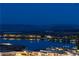 Picturesque night view of a waterfront community with reflective waters and mountain backdrop at 8 Laricola Ct, Henderson, NV 89011