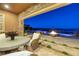 Outdoor patio featuring mountain views, stone, fire pit, and seating area with table and chairs at 8 Laricola Ct, Henderson, NV 89011