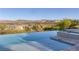 Infinity pool overlooking a scenic mountain and lake view in a serene environment at 8 Laricola Ct, Henderson, NV 89011