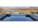 Infinity pool overlooking a scenic mountain and lake view in a serene environment at 8 Laricola Ct, Henderson, NV 89011