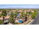 Expansive aerial view showcasing a beautiful pool, lush landscaping, and a charming neighborhood at 8205 Taos Paseo Ave, Las Vegas, NV 89128