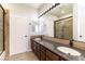 Bathroom featuring double sinks, granite countertops, and a walk-in shower at 8205 Taos Paseo Ave, Las Vegas, NV 89128