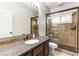Bathroom featuring granite countertops, vanity, and walk-in shower with glass enclosure at 8205 Taos Paseo Ave, Las Vegas, NV 89128