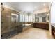 Luxurious bathroom with a glass shower, soaking tub, double vanity, and modern fixtures at 8205 Taos Paseo Ave, Las Vegas, NV 89128