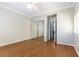 Bedroom with hardwood floors, neutral walls, crown molding, and mirrored closet doors at 8205 Taos Paseo Ave, Las Vegas, NV 89128