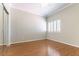 Bedroom with hardwood floors, neutral walls, crown molding, and sliding mirror door closet at 8205 Taos Paseo Ave, Las Vegas, NV 89128