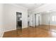 Bedroom featuring hardwood floors, mirrored closet doors, and an open doorway at 8205 Taos Paseo Ave, Las Vegas, NV 89128