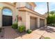Elegant home featuring a three-car garage and manicured landscaping at 8205 Taos Paseo Ave, Las Vegas, NV 89128