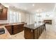 Bright, open kitchen featuring granite countertops, dark wood cabinets, and stainless steel appliances at 8205 Taos Paseo Ave, Las Vegas, NV 89128