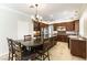 Gourmet eat-in kitchen with an island, dark wood cabinets and stainless steel appliances at 8205 Taos Paseo Ave, Las Vegas, NV 89128