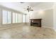 Spacious living room featuring tile floors, a fireplace and large windows with white shutters at 8205 Taos Paseo Ave, Las Vegas, NV 89128