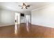 Living room featuring hardwood floors, a ceiling fan, and custom built-in storage at 8205 Taos Paseo Ave, Las Vegas, NV 89128
