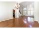 Bright living room with hardwood floors, staircase and modern chandelier at 8205 Taos Paseo Ave, Las Vegas, NV 89128