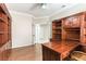Office space featuring wood built-ins, desk and hardwood floors with open doorway at 8205 Taos Paseo Ave, Las Vegas, NV 89128