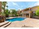 Inviting backyard pool area featuring lush landscaping and a private outdoor space at 8205 Taos Paseo Ave, Las Vegas, NV 89128