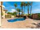 Backyard swimming pool with palm trees, lush landscaping, and waterfall feature at 8205 Taos Paseo Ave, Las Vegas, NV 89128