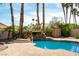 Backyard swimming pool featuring a waterfall feature and mature landscaping at 8205 Taos Paseo Ave, Las Vegas, NV 89128