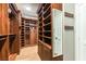 Custom walk-in closet with wood organizers, shelves, and drawers for ample storage at 8205 Taos Paseo Ave, Las Vegas, NV 89128