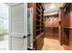 Custom walk-in closet with wood organizers and shelves; access to the bathroom visible at 8205 Taos Paseo Ave, Las Vegas, NV 89128