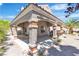 Covered outdoor kitchen with brick columns and well-maintained landscaping at 8437 Apple Hill Ct, Las Vegas, NV 89128