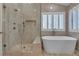 The bathroom features a glass-enclosed shower, soaking tub, and white shuttered window at 8437 Apple Hill Ct, Las Vegas, NV 89128