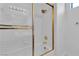 Bathroom highlighting the tiled bathtub and shower with gold trim at 8437 Apple Hill Ct, Las Vegas, NV 89128