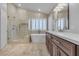 Bright bathroom features a modern soaking tub, glass enclosed shower, and double sink vanity at 8437 Apple Hill Ct, Las Vegas, NV 89128