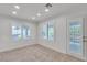 Sunlit bedroom with tiled floors, shuttered windows, and a glass paneled door at 8437 Apple Hill Ct, Las Vegas, NV 89128