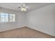 Neutral bedroom with a bright window and ceiling fan at 8437 Apple Hill Ct, Las Vegas, NV 89128