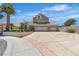 Traditional home with a three-car garage, tile roof, desert landscaping and circular driveway at 8437 Apple Hill Ct, Las Vegas, NV 89128