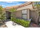 Close-up view of home featuring desert landscaping, an iron gate and trimmed hedges at 8437 Apple Hill Ct, Las Vegas, NV 89128