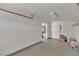 Spacious garage interior featuring neutral paint, epoxy floors, and access to the home at 8437 Apple Hill Ct, Las Vegas, NV 89128