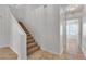 Staircase leads to an upstairs hallway with tile flooring and neutral decor at 8437 Apple Hill Ct, Las Vegas, NV 89128