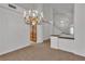 Hallway view features a chandelier, neutral walls, and staircase at 8437 Apple Hill Ct, Las Vegas, NV 89128