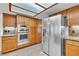 Spacious kitchen equipped with stainless steel refrigerator and double ovens at 8437 Apple Hill Ct, Las Vegas, NV 89128