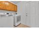 A clean, functional laundry room with modern appliances, cabinetry, and a door at 8437 Apple Hill Ct, Las Vegas, NV 89128